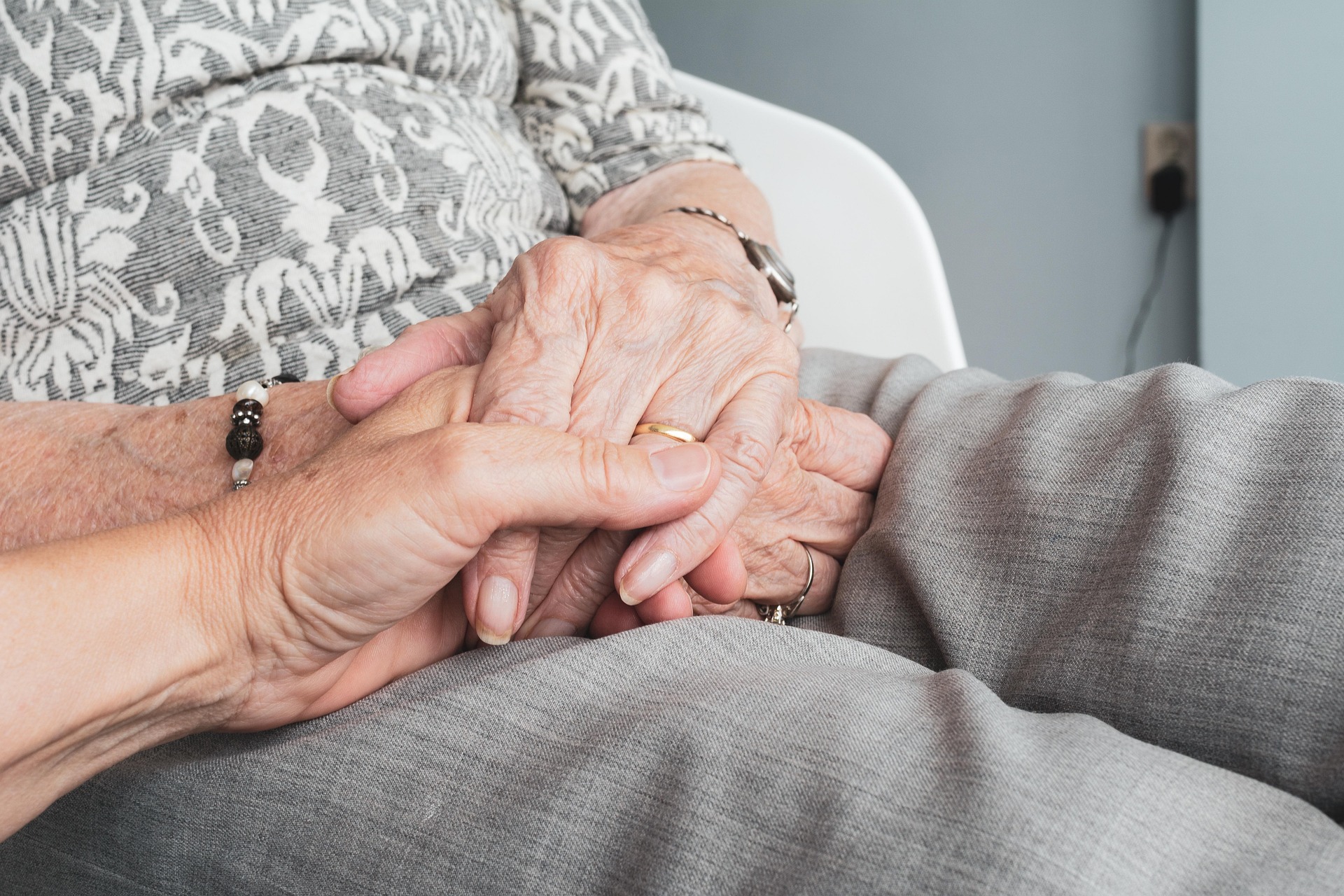 Caregiver holding hands with client